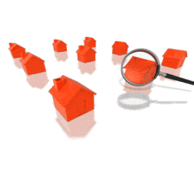 A magnify glass looks at different a houses.