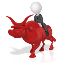 A businessman riding on the back of a bull.