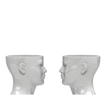 An animation of a two open heads with two arrows pointing into each other representing sharing ideas.