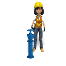 A female construction worker tightens a nut on a valve.