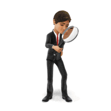 A businessman uses a large magnifying lens to search for something.