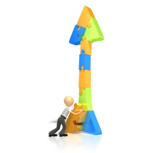 A stick figure places the last piece of the puzzle in an arrow pointing up in this clipart.