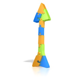 An arrow made up of different colored puzzle pieces points upward in this clipart.