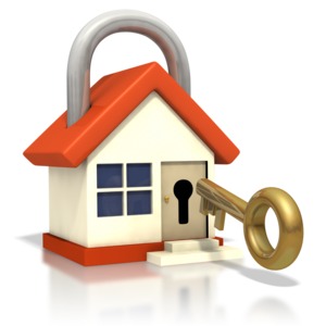 This clipart image shows an old-school golden key being inserted into a house with a lock top coming from the roof.