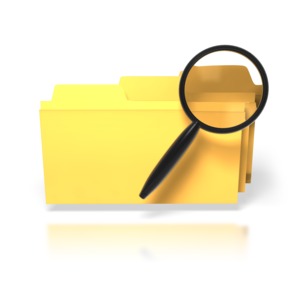 An image of three yellow file folders with a black magnifying glass in front of them.  This image would be a good icon to indicate search, research, or the process of finding something.