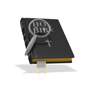 A concept image of Bible Study.  A silver magnifying glass focuses on the Holy Bible.  In addition to illustrating a Bible study, this image could also be used for a sermon or a class on religion.