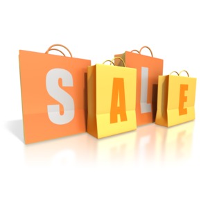 An image of four yellow and orange gift bags in a line.  The shopping bags spell out the word SALE.  A great concept image for upcoming sales events.