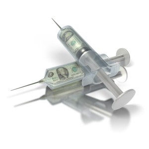 In this clipart two syringes are full of liquid money.  This clipart graphic could be used to illustrate the rising health care costs