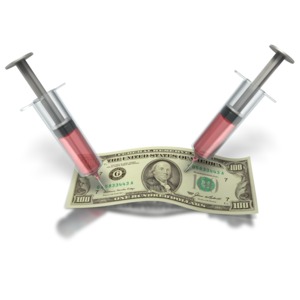 An image of two medical syringes struck into a hundred dollar bill.  This is a concept for the cost of health care or the expense of medicine.