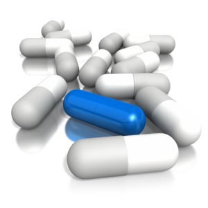This is an image of a pile of pills with one blue pill sticking out from the rest. This graphic represents standing out from the rest of the crowd.