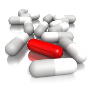 This is an image of a pile of pills with one red pill sticking out from the rest. This graphic represents standing out from the rest of the crowd.