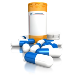 This image contains an orange pill bottle with a blank label and pills in front of the bottle.