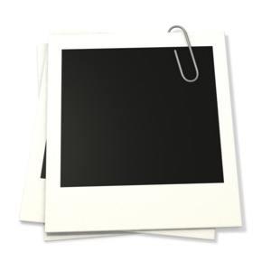 An image of photographs held together by a paper clip.