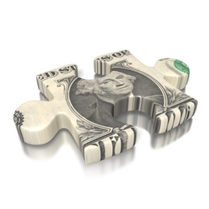 A 3D image of a puzzle piece shaped out of a US one dollar bill.  A concept for a financial piece of the puzzle. 