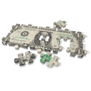 An image of a one dollar bill on a puzzle.  Three pieces of the puzzle are missing.  A concept of solving a financial problem, or building a profit or business.