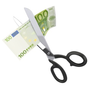 An image of a hundred Euro being cut up by a pair of scissors.
