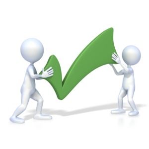 An image of two 3D figures holding a green check mark.  A concept of a team completing a task or project.  A sign of approval.