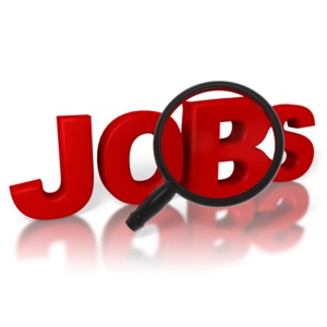 A magnifying glass examines the word jobs in this job search concept.