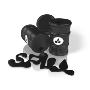 A large black barrel of oil is tipped over and spilling oil onto the ground.  A concept of an oil spill or pollution.