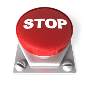 A 3D image of a red push button with the word STOP printed on it.  A concept of a warning or to indicate a stop action.
