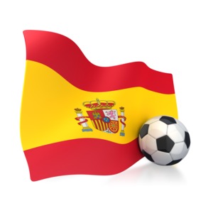 This clip art image shows a Spain flag with a soccer ball sitting next to it.  