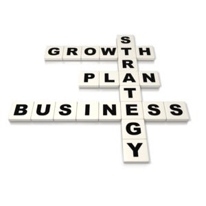 A 3D image of letter tiles spelling out business concepts such as growth strategy, and plan.  A concept of building a business plan or devising a business strategy for growth.