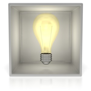 This clip art image shows a light bulb lite up inside of an open faced cube.