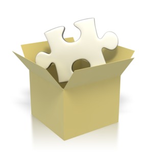 This clip art image shows a silver puzzle piece inside of a brown box.