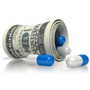this clip art image shows a money roll with medicine pills falling out of it.  This graphic displays the concept of rising healthcare costs, and high costs of pharmaceutical medication. 