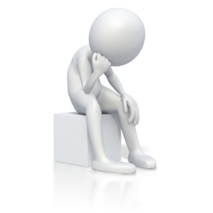 This clip art image shows a stick figure sitting on a box bummed out resting its head on its fist.