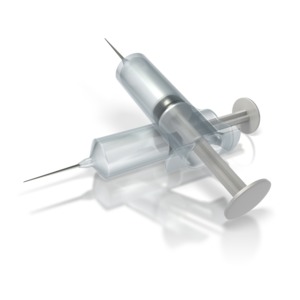 This clip art image shows two medical syringes.