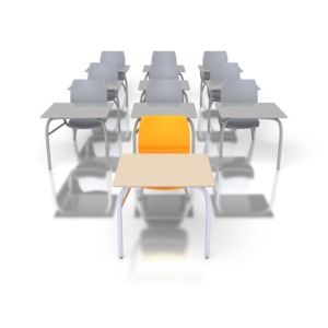 A single desk sits in front of rows of desks in a classroom.  A concept of head of the class or standing out academically. 
