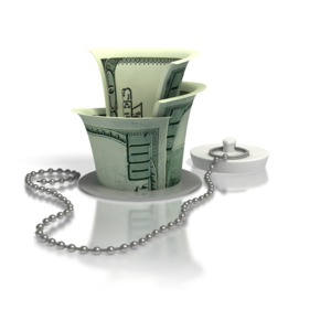 A concept image of pouring money down the drain.  A metaphor for wasteful spending or not getting the results that were expected.