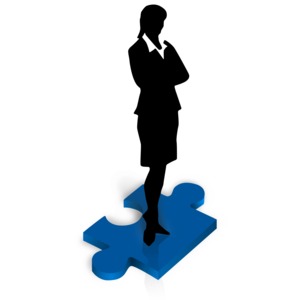 An image of a businesswoman standing on a red puzzle piece.