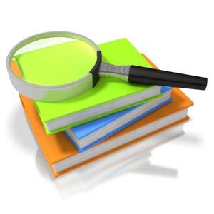 Three colorful books are stacked on each other with a magnify glass on top.  This presentation clip art shows the concept of searching or researching through books.