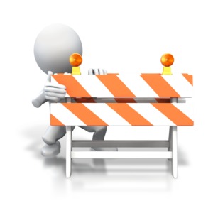 An image of a stick figure hiding behind a construction a road blockade.