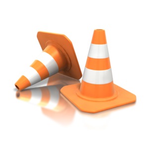 An image of a pair of construction cones with one tipped over.