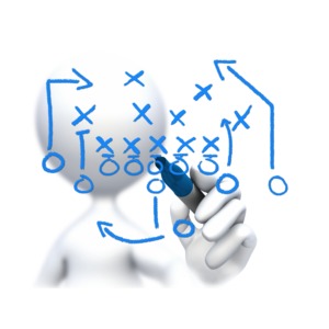 An image of a stick figure drawing a game plan with a felt tip pen.