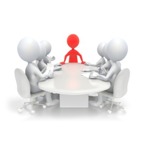 A group of business people around a conference table.  The leader is standing and is highlighted in red.  Use the hue slider in the customizer to change the color of the leader.