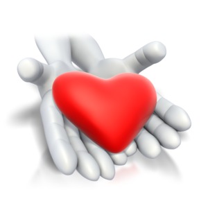 This image shows two hands stretched out with a heart lying in them.