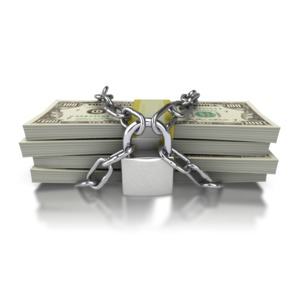Stacks of one hundred dollar bills are chained together and secured with a large lock.  A concept clipart image of protecting your investment or keeping your money safe.