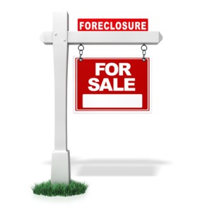 This clip art image shows a real estate sign with a bank foreclosure sing on top.