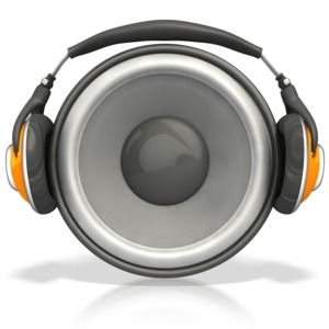 A pair of headphones sits around an audio speaker.