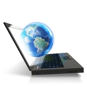 An image of a world appearing out of a laptop computer.
