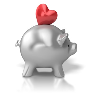 A heart is deposited into a piggy bank in this concept of giving compassion, kindness, or saving.