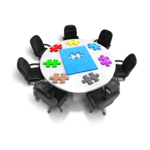 An image containing a round table with puzzle pieces on top.