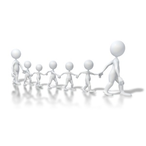 An image of a line of children walking with a adults.