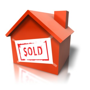 An image of a house that has a sold sign slapped on the side.