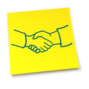 An image of a yellow sticky note with a sketch of a handshake.
