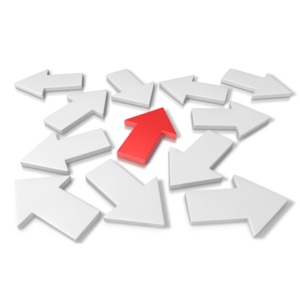 A single highlighted arrow points in the way in a sea of arrows pointing different directions.  A concept of picking the right choice or the correct direction.